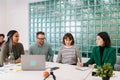 Modern corporate office open space with busy male and female staff employees using laptop computers sitting at work in Royalty Free Stock Photo