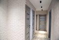 Modern corridor in an apartment after renovation in gray tones. Gray interior doors and black LED lights on the ceiling Royalty Free Stock Photo