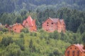 Modern cottages on slopes of forested mountains Royalty Free Stock Photo