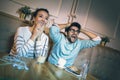 Modern couple in cafe looking football match on tv in cafe.