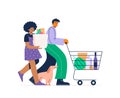 A modern couple with a shopping cart filled with goods and daily supplies. Buying food in a grocery store. Royalty Free Stock Photo
