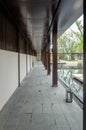 Minimalist Covered Corridor with Reflective Water Feature and Vertical Slats Royalty Free Stock Photo