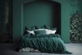 Modern cozy bedroom with monochrome forest green wall. Contemporary interior design with dark wall color, bed and pillows. Royalty Free Stock Photo