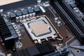 Modern CPU processor installed on a brand new motherboard, object detail, extreme closeup, nobody. Simple generic powerful high