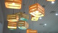 Modern creative ceiling chandeliers in the interior of wooden drawers with light bulbs inside.