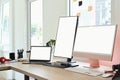 Modern creative office studio interior with laptop, blank screen computer and supplies on wooden table Royalty Free Stock Photo