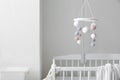 Modern crib with baby mobile in children's room. Interior design Royalty Free Stock Photo