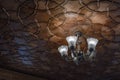 Modern crystal glass chandelier ceiling lamp lighting bulbs with beautiful carved wooden ceilings interior for home and living Royalty Free Stock Photo