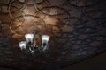 Modern crystal glass chandelier ceiling lamp lighting bulbs with beautiful carved wooden ceilings interior for home and living Royalty Free Stock Photo