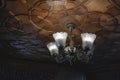 Modern crystal glass chandelier ceiling lamp lighting bulbs with beautiful carved wooden ceilings interior for home and living Royalty Free Stock Photo