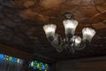 Modern crystal glass chandelier ceiling lamp lighting bulbs with beautiful carved wooden ceilings interior for home and living Royalty Free Stock Photo