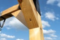 A modern cubic playground made of wooden logs and metal corners, visible steel corners.