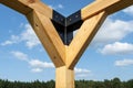 A modern cubic playground made of wooden logs and metal corners, visible steel corners.