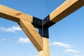 A modern cubic playground made of wooden logs and metal corners, visible steel corners.