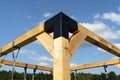 A modern cubic playground made of wooden logs and metal corners, visible steel corners.