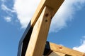 A modern cubic playground made of wooden logs and metal corners, visible steel corners.