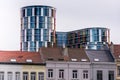 Modern curved building with glass walls behind a block of old buildings in Brussels, Belgium