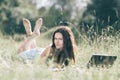 Modern cute girl relaxarea on the fresh grass. Royalty Free Stock Photo