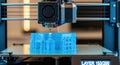 Modern 3d printer creating a detailed translucent blue architectural model Royalty Free Stock Photo