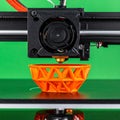 Modern 3D Printing Technology Creating an Orange Model Royalty Free Stock Photo