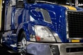 Modern dark blue custom semi truck tractor with lot of light ref Royalty Free Stock Photo