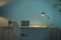 Modern dark blue designer office workplace with various items, empty mock up laptop screen, decorative plant and lamp. Workspace Royalty Free Stock Photo