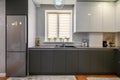 Modern dark grey small kitchen interior, front view