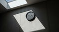 Modern Dark Grey Wall Clock: Minimalist Design in Sunlit Interior Royalty Free Stock Photo