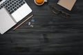 Modern dark wood office desk table with laptop, smartphone and other supplies with cup of coffee. coppy space for input the text Royalty Free Stock Photo