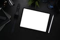 Dark workplace with digital tablet, smart watch, stylus pen and notebook on black leather. Royalty Free Stock Photo