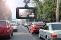 Modern dashboard camera mounted in car, view of road