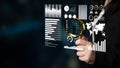 Modern Data Analysis Concept with Hand Holding Magnifying Glass Above Digital Interface of Statistical Charts and Graphs Royalty Free Stock Photo