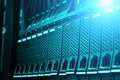 Modern data center disk storage perspective closeup with blue light Royalty Free Stock Photo