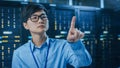 In the Modern Data Center: Portrait of IT Engineer Working With Touch Screen Device, Doing Touchin Royalty Free Stock Photo