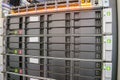 Modern database servers with multiple hard drives work in the server rack. The computing equipment is located in the data center.