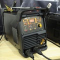 Modern DC inverter MMA welder, household electric welding machine, placed on a stand