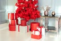 Modern decorated Red Christmas tree with gifts in living room. Happy new year interior background. Royalty Free Stock Photo