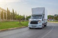 Modern delivery small shipment cargo courier frobt view van moving fast on motorway road turn city urban suburb. Busines Royalty Free Stock Photo