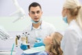 Modern dental clinic, young dentist working Royalty Free Stock Photo