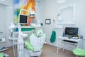 Modern dental office with green chair and professional tools Royalty Free Stock Photo