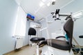 Modern dentistry office interior with chair and tools. Microscope in stomatology.