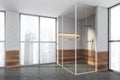 Modern design bathroom interior with shower cabin, bronze faucets. Panoramic window with skyscrapers city view. Wood and concrete Royalty Free Stock Photo