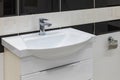 Modern design bathroom sink in a modern residential building or hotel. Modern white bathroom sink with a tap. Selective focus Royalty Free Stock Photo