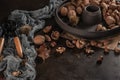 Modern design black ceramic bowl with walnuts, hazelnuts, almonds, chestnut hedgehogs on dark countertop and background. Autumn Royalty Free Stock Photo