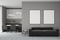 Modern design living dining room and kitchen interior with two empty white framed mockup poster on wall, sofa, table, carpet Royalty Free Stock Photo