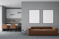 Modern design living dining room and kitchen interior with two empty white framed mockup poster on wall, sofa, table, carpet Royalty Free Stock Photo