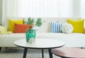 Modern design of living room with yellow,blue and orange pillow on sofa. Royalty Free Stock Photo