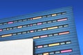 Modern design office block with colorful facade against a blue sky background Royalty Free Stock Photo