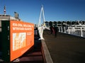 Modern white entry bridge of Wynyard Crossing with handrails in blue sky, Wynyard Quarter, Auckland, New Zealand