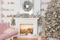 Modern design of the room with fireplace in light colors decorated with Christmas tree and decorative elements. New Year Royalty Free Stock Photo